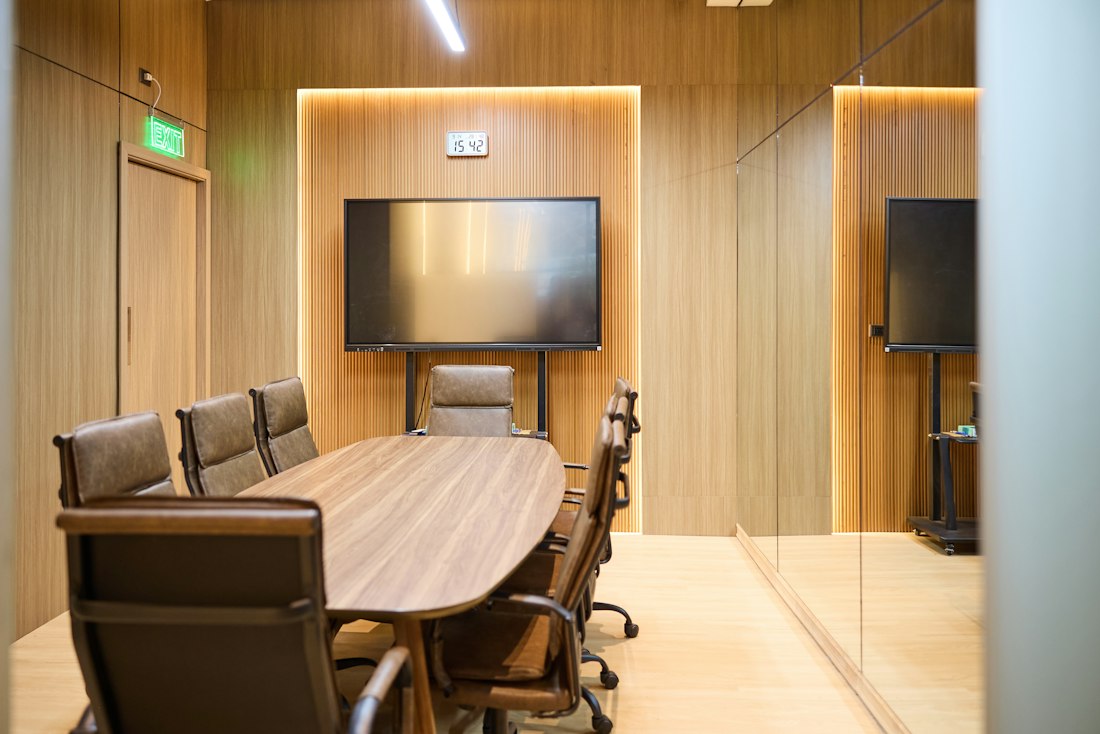 Modern conference room with a wooden boardroom table