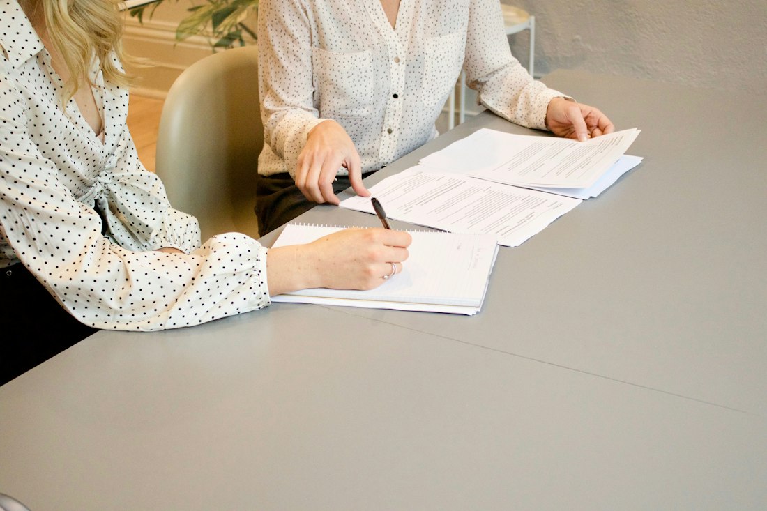 Person signing a contract with a pen