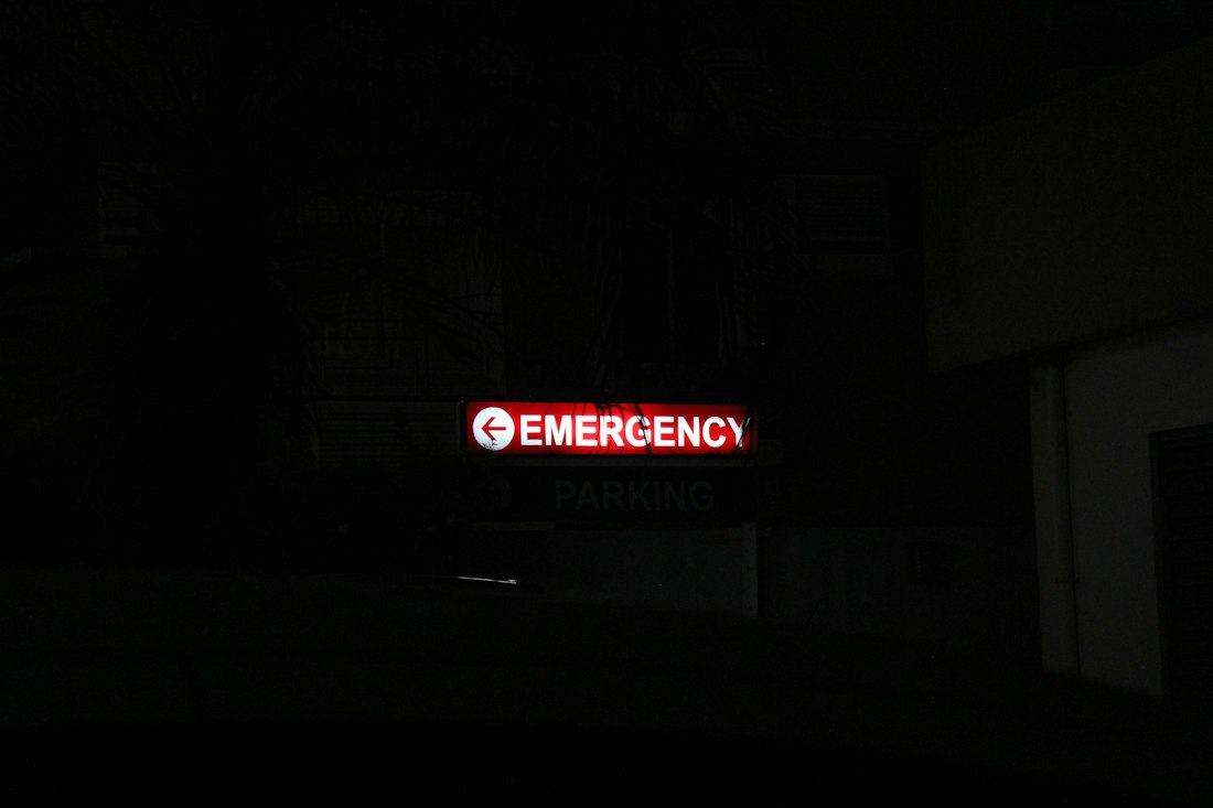 Red emergency sign lit in the dark