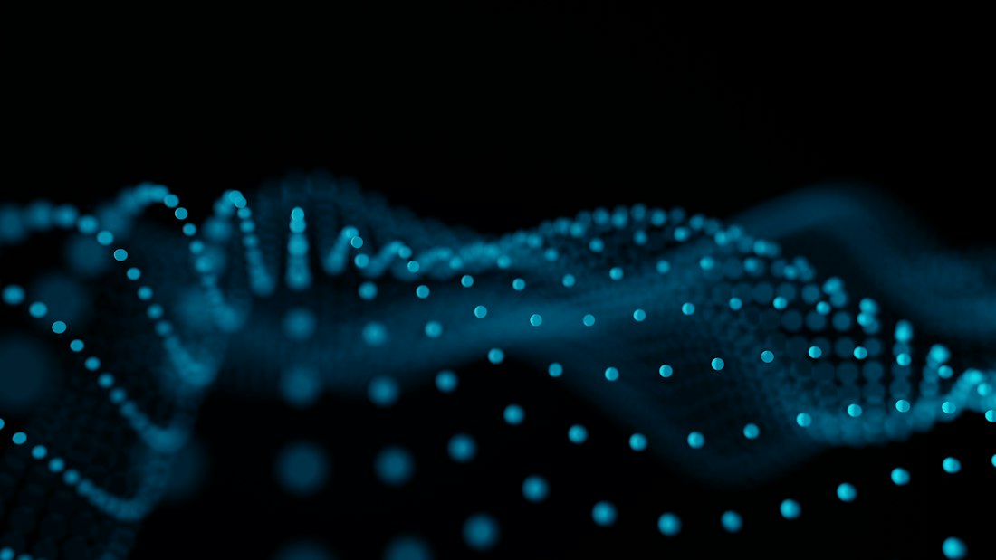 Abstract blue glowing dots forming a wave