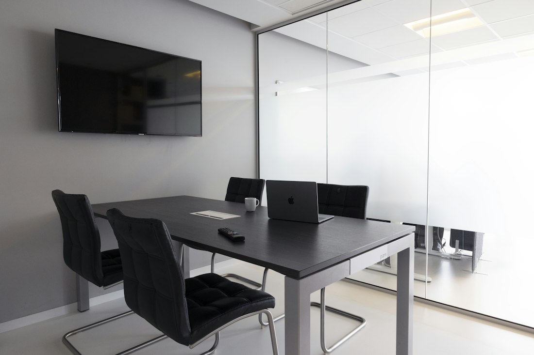 Conference room with a wall-mounted display and meeting table